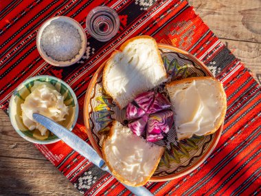 pork lard spread on bread served with red onion and salt and glass of plum brandy aside clipart