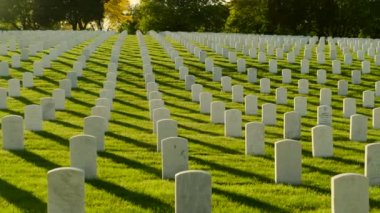 Memorial Day Veterans Cemetery. Arlington National Cemetery panning shot at sunset. america Christian Cemetery pan, Catholic faith white stone tomb. 