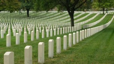Sunset 'te Amerikan bayrakları. Mezarlıktaki anma günü anısına mezar taşlarında bayraklar var. Ulusal Mezarlıkta küçük Amerikan bayrakları ve mezar taşları Anma Günü sergisi.