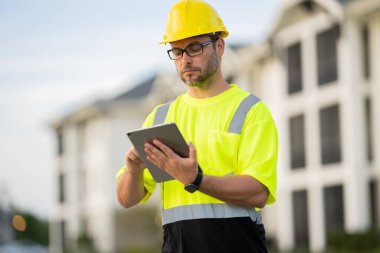 A construction worker in highvisibility gear emphasizes safety and professionalism at a dusty work site clipart