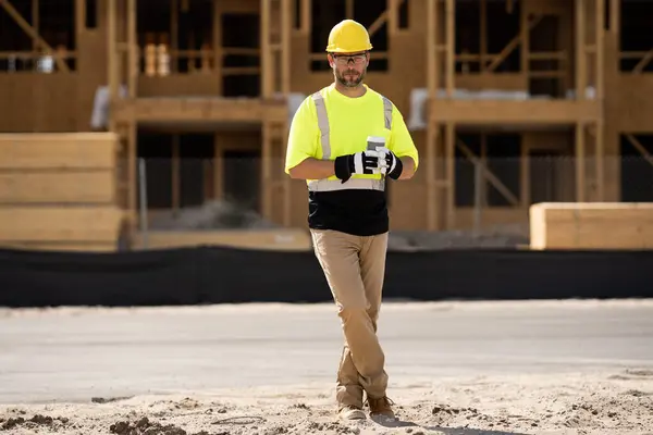 stock image A construction worker in highvisibility gear emphasizes safety and professionalism at a dusty work site