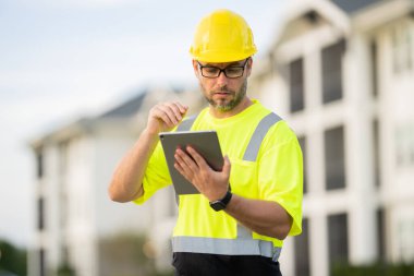 A construction worker in highvisibility gear emphasizes safety and professionalism at a dusty work site clipart