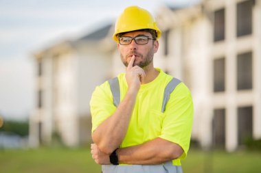 İnşaat işçisi inşaat alanında kahve molası veriyor. Miğferli bir inşaatçı. Şapkalı bir işçi. İnşaat miğferinde portre mekaniği işçisi. Mühendis ustabaşı veya tamirci..