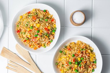 Bulgur with vegetables in a white plate close-up