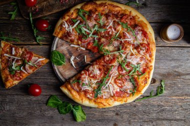 Ahşap arka planda jambonlu iştah açıcı pizza.