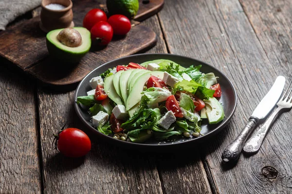 stock image Salad with feta cheese, avocado and tomatoes in a bowl