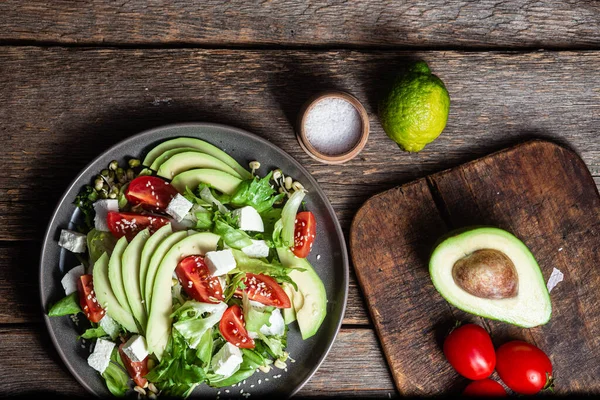 stock image Salad with feta cheese, avocado and tomatoes in a bowl