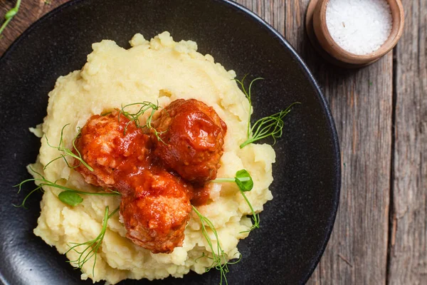 stock image Mashed potatoes with meatballs in tomato sauce in a bowl