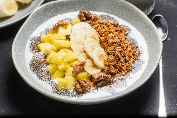 stock image Granola with yogurt, mango, banana and chia in a bowl