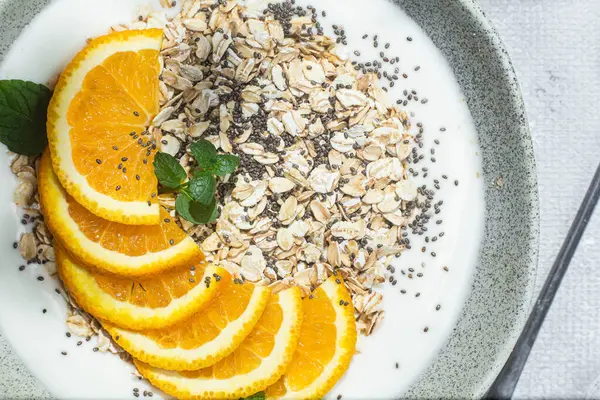 stock image Oatmeal with orange and chia in a bowl .Oatmeal