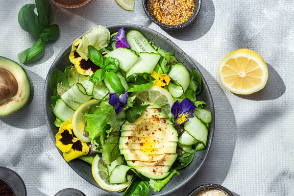 Salad of greens, avocado and cucumbers .Food styling