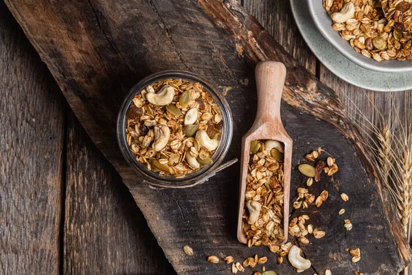 Stock image Granola with nuts, raisins and pumpkin seeds in a glass jar