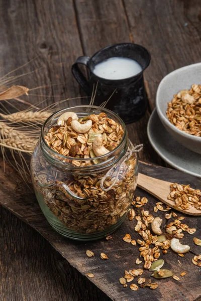 stock image Granola with nuts, raisins and pumpkin seeds in a glass jar
