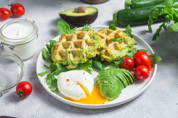 Kabaklı waffle, haşlanmış yumurta, avokado ve vişneli domates.