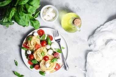 Mozzarella, domates, fesleğen ve pesto soslu spagetti. Makarna Kapsülü