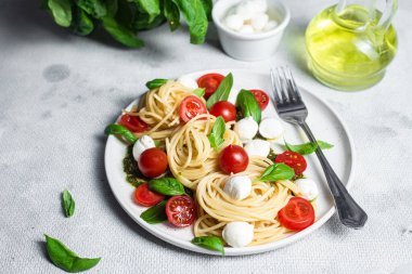 Mozzarella, domates, fesleğen ve pesto soslu spagetti. Makarna Kapsülü