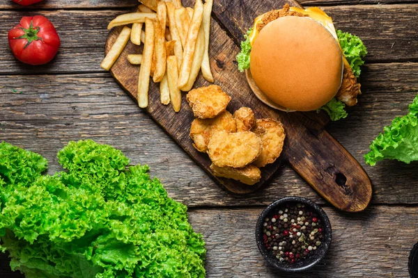 stock image Cheeseburger, Potato, nuggets on a wooden board