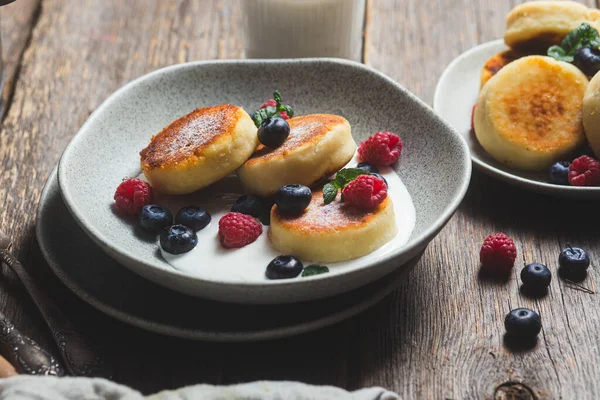 stock image Cottage cheese pancakes with creamy sauce, raspberries and blueberries