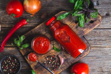 Kavanozda ketçap. Koyu arkaplanda domates sosu