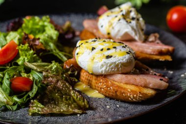Tabakta haşlanmış yumurtalı tost. Salata.