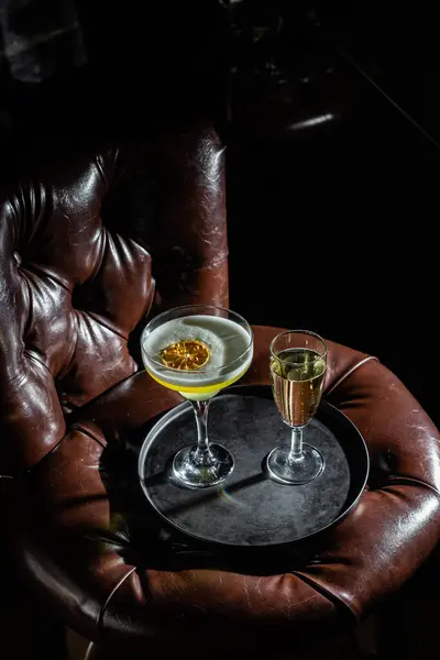 Cocktail with ice on a dark background. Bar
