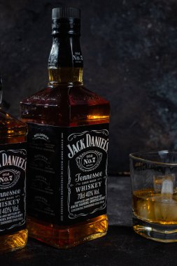 Karanlık bir arka planda bir şişe viski.
