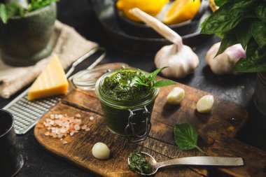 Masadaki cam kavanozda yeşil fesleğen sosu