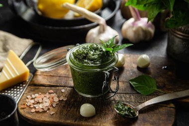 Masadaki cam kavanozda yeşil fesleğen sosu