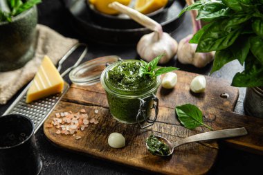 Masadaki cam kavanozda yeşil fesleğen sosu