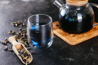 Tibet Anchan çayı, arka planda koyu bir yakın plan. Mavi çay.