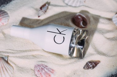 Calvin Klein CK IN2U bottle on sand clipart