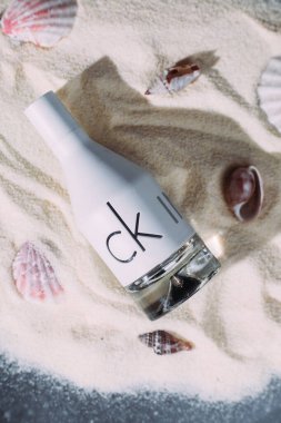 Calvin Klein CK IN2U bottle on sand clipart