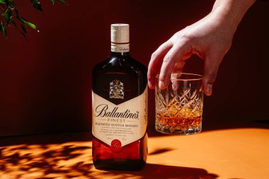 Siyah arka planda bir şişe Ballantine 's Whiskey.
