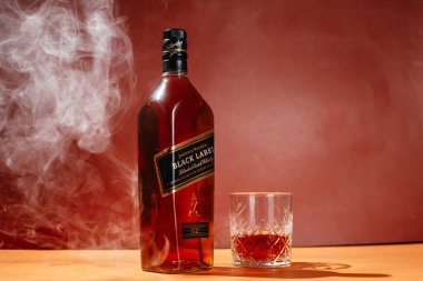  Bir şişe Black Label Whiskey, sarı arka planda Johnnie Walker.