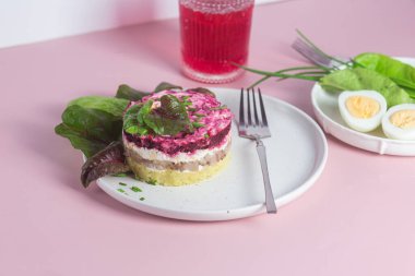 Ringa balıklı salata ve tabakta pancar. Kürk mantonun altında salata.