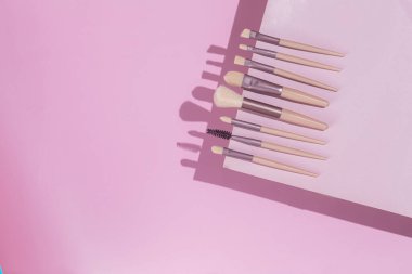 Pembe arka planda makyaj fırçaları. Kozmetik.