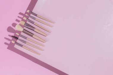Pembe arka planda makyaj fırçaları. Kozmetik.