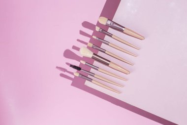 Pembe arka planda makyaj fırçaları. Kozmetik.