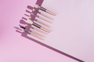 Pembe arka planda makyaj fırçaları. Kozmetik.