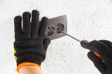 Adam elektrik prizinde vidalanıyor.