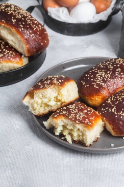 Masadaki tabakta yumurta ve susam tohumlu fırında turtalar. Maya turtaları.