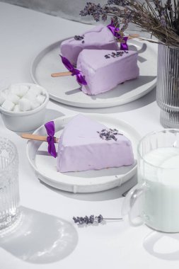 Masadaki beyaz tabakta peynirli kek. Cilalı cheesecake. Tatlı.