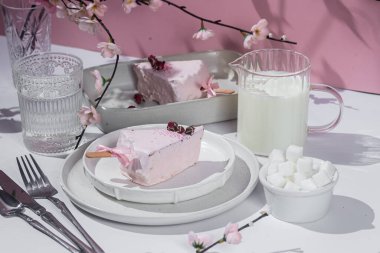 Masadaki beyaz tabakta peynirli kek. Cilalı cheesecake. Tatlı.