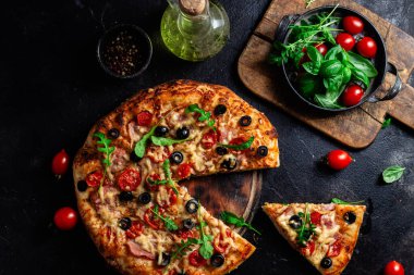 Jambonlu, domatesli ve peynirli iştah açıcı pizza. İnce pizza.