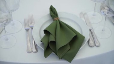 Gözlüklü ve tabaklı bir düğün resepsiyonu için masa ayarlama. Kapalı resepsiyon salonu.