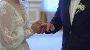 Gelin ve damat düğün töreninde. Adam bir kadın parmağına yüzük taktı. Takı yüzükleri, aşkın sembolü..