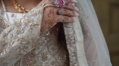 Büyüleyici bir düğün töreninde sevgi dolu bir çiftin el ele tutuşmasını gösteren çok güzel bir an.