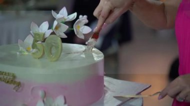 Çiçek aksanıyla süslenmiş 50. yaş gününün kutlamalarını gösteren nefis tasarlanmış bir pasta.