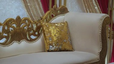 Bu sofistike kanepe karmaşık bir tasarım ve pırıl pırıl altın bir yastık içeriyor, lüks ortamlar için ideal.