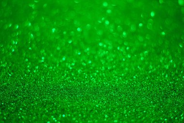 Yeşil parıltılı arkaplan. Yeşil parıltılı parçacıkların dokusu..